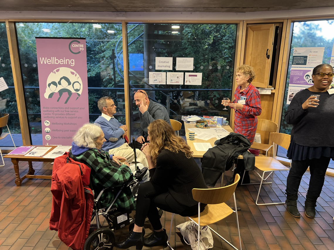 A range of people sitting and standing having different conversations