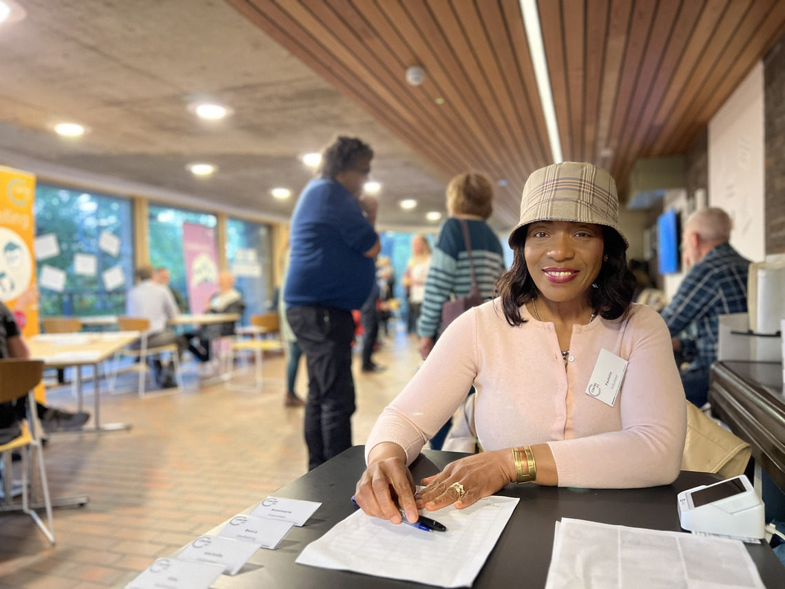 Entrance to C70 Open Evening with Paulette welcoming people in